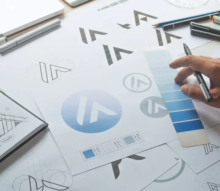 Logo and brand identity sketches on the design desk